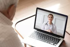 elderly man having online video consultation with doctor