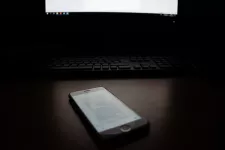 Phone in front of computer