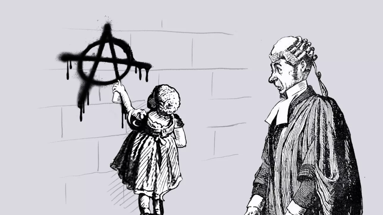 A judge is watching a girl spray paint an anarchist A on a wall.
